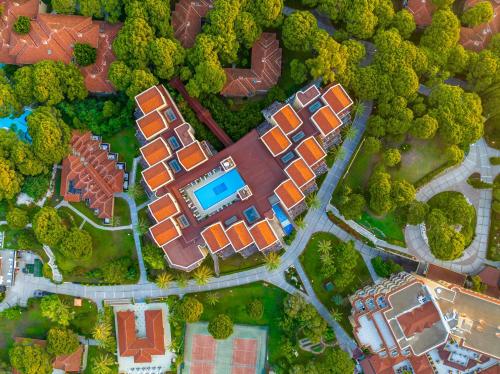 an overhead view of a city with a house and trees at Asteria Family Resort Belek in Belek