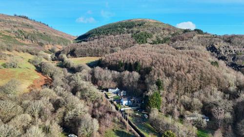 an aerial view of a house in the middle of a mountain at Peaceful Haven: Nature, Luxury, Wellbeing & Cuisine in Risca