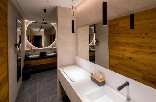 a bathroom with a white sink and a mirror at Apartmány Jarmilka in Bedřichov