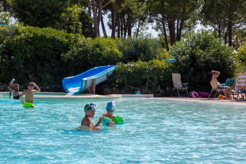 a group of people in a swimming pool at Estivo Premium Deluxe mobile homes on Camping Del Sole Village in Iseo