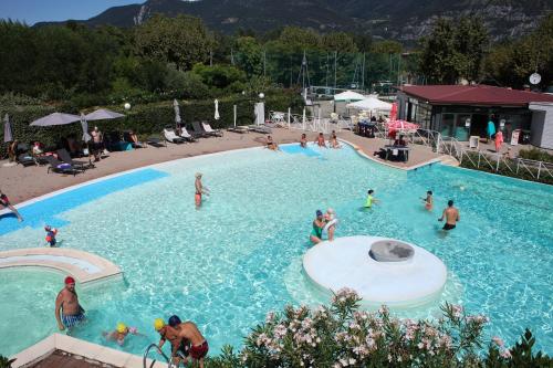 a group of people in a large swimming pool at Estivo Premium Deluxe mobile homes on Camping Del Sole Village in Iseo