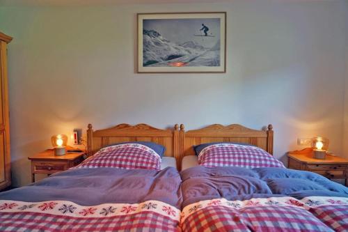 a bedroom with two beds and two night stands at Das Ferienhaus in Achenkirch in Achenkirch