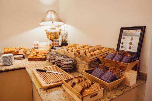 a counter with many baskets of bread and pastries at Hotel Villa Toskana in Leimen