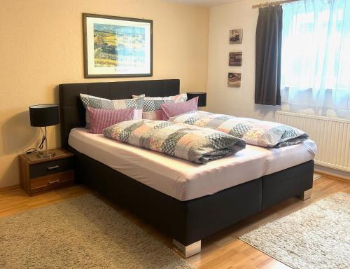 a bedroom with a large bed with pillows on it at Landhaus Ostermann in Umhausen