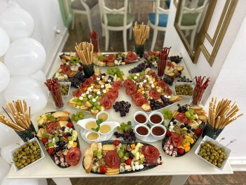 a table filled with different types of food at Hotel Restaurant Casa Cu Tei Craiova in Craiova