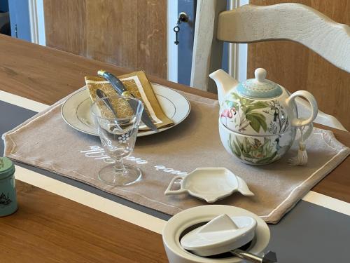 a table with a tray with a tea set on it at La BOCQUILLONNE 
