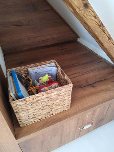 a drawer with a basket of books and toys at Apartmán v Podkroví in Kremnica