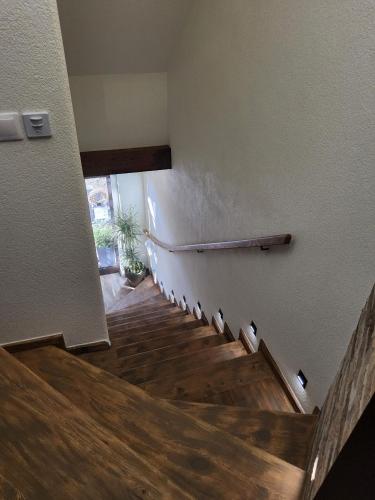 a staircase in a house with wooden floors at Apartmán v Podkroví in Kremnica