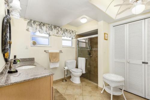 a bathroom with a toilet and a sink and a shower at Villa Catalina Isles - Holidays in Paradise in Cape Coral