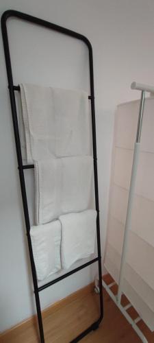 a towel rack with white towels in a room at Markesa in Plasencia