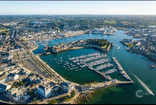 an aerial view of a marina with boats in the water at Cœur de Concarneau, appartement entier, proche centre, corniche et plage avec parking in Concarneau