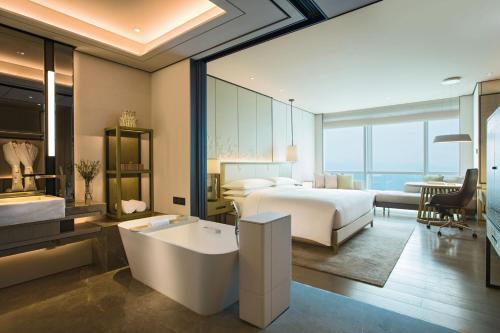 a hotel room with a bed and a bath tub at Shenzhen Marriott Hotel Nanshan in Shenzhen