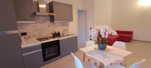 a kitchen with a table with a vase of flowers on it at Casa Pereira in Rome