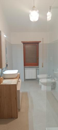 a bathroom with two sinks and a tub and two toilets at Casa Pereira in Rome