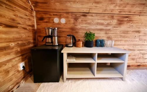 a small table with a blender on top of a refrigerator at Cozy Cabin Styled Loft in Kiruna