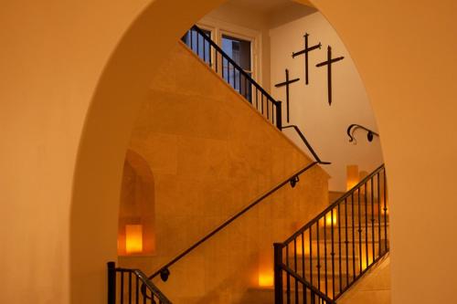 an arched stairway with crosses on the wall at Hotel St Francis in Santa Fe