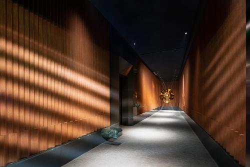 a hallway with shadows on the wall of a building at W Suzhou - Jinji Lake in Suzhou