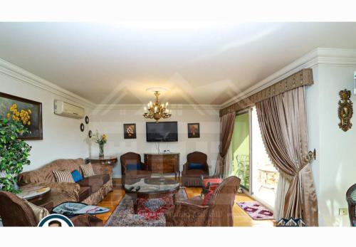 a living room with a couch and a table at تراس سموحه - بيتك يطل علي نادي سموحه in Alexandria