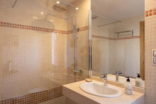 a bathroom with a sink and a shower at Villa Experience Heated Salty Water Pool in Caleta De Fuste