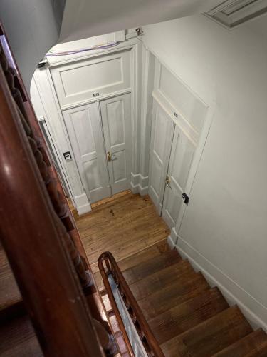 a stairway with a white door and a stair case at A Beira Hostel in Aveiro