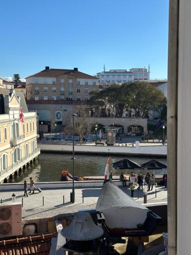 a view of a city with a river and buildings at A Beira Hostel in Aveiro