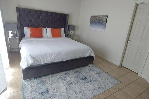 een slaapkamer met een groot bed met oranje kussens bij Luxury living in 2 beds 2 baths near Fort Cavazos in Killeen