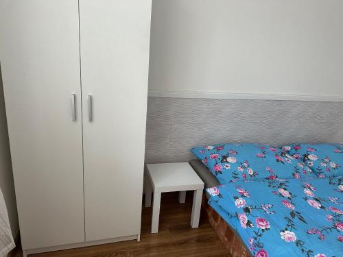 a bedroom with a bed and a white cabinet at Penzion Sokolov 1 in Sokolov