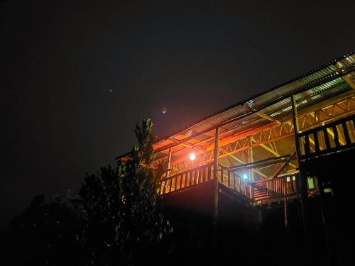 a building at night with lights on it at Bwindi Neckview Lodge in Buhoma