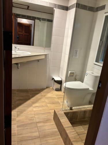 a bathroom with a toilet and a sink and a mirror at Grand view @lamaibeach in Koh Samui 