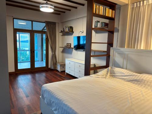 a bedroom with a bed and a television in it at Grand view @lamaibeach in Koh Samui 