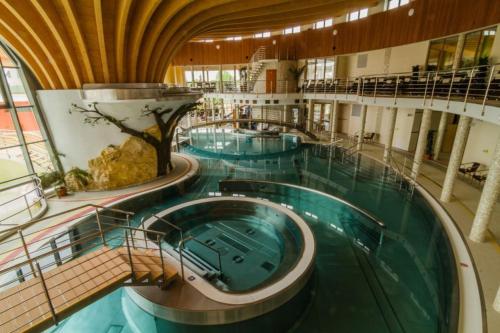 a large swimming pool in a large building at Penzión Vilka Podhájčanka in Podhájska