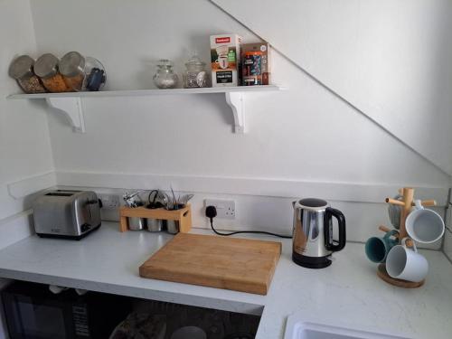 a kitchen with a counter top with a coffee maker at The Flat at Conway House in Overstrand