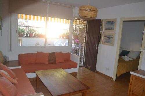 sala de estar con sofá y mesa en Apto. piscina y acceso al mar, en Sant Feliu de Guíxols