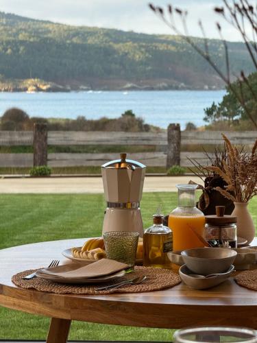 a table with food and a blender on top of it at Balarés Hotel da Natureza in Ponteceso