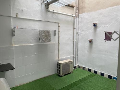 un gimnasio con suelo verde y una pared con radiador en PARRA HOME y garaje, Algemesi Home, en Algemesí