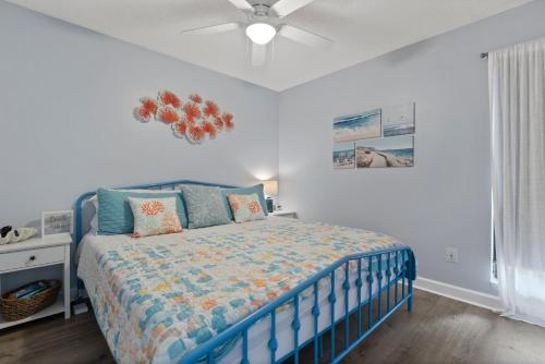 a bedroom with a blue bed and a ceiling fan at Beachfront, Updated, Topsail Dunes Shining Sea in North Topsail Beach