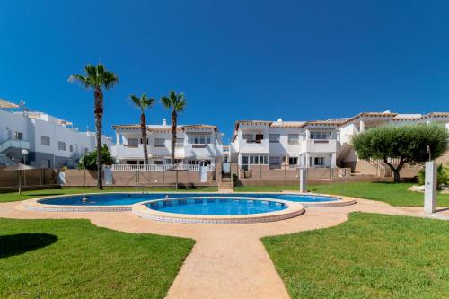 a villa with a swimming pool and palm trees at Espanatour CINUELICA III in Orihuela Costa