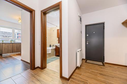 a hallway with a black door and a bathroom at Casa MILISMA in Braşov