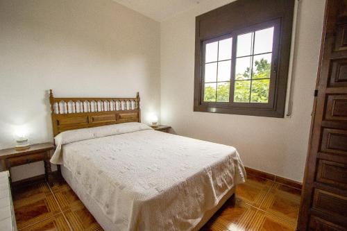 a bedroom with a large bed and a window at Catalunya Casas Private pool with access to BCN and Costa Brava! in Sils