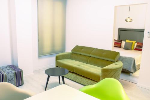 a living room with a couch and a bed at Santa Cruz Apartments in Málaga