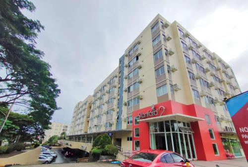 a red car parked in front of a building at Condo in Silang near Nuvali - Dy's Haven Suites in Silang