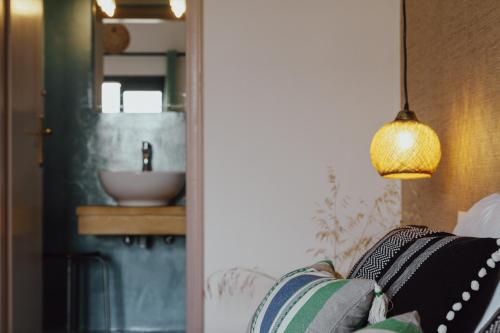 a living room with a couch and a sink at Anemos Inn by Estia in Kokkíni Khánion