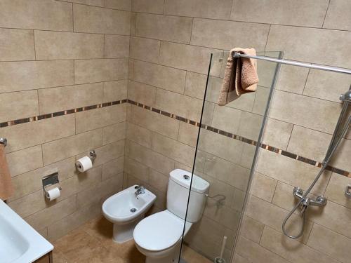 a bathroom with a toilet and a sink and a shower at Las Brisas, Villa 98 in Playa Blanca