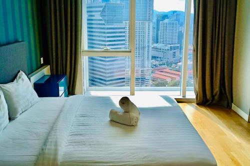 a bedroom with a large window with a large bed at amazing suites at platinum suites in Kuala Lumpur