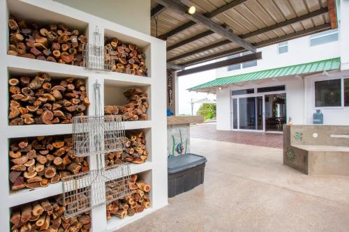 a bunch of fire wood in racks on the side of a building at Kangela 2 in Ponta Malongane