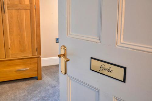 a door with a sign that says little on it at Finest Retreats - The Old Counting House in Gweek
