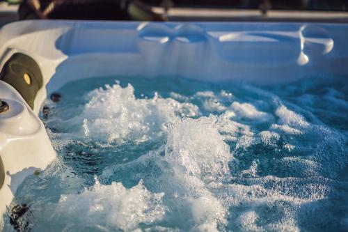 a bath tub filled with snow and water at Finest Retreats - The Old Counting House in Gweek
