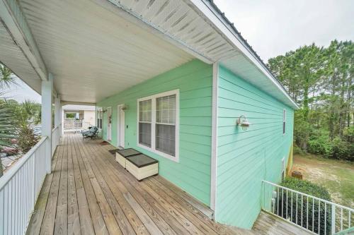 a green and white house with a wooden deck at 30A Getaway Too! in Santa Rosa Beach