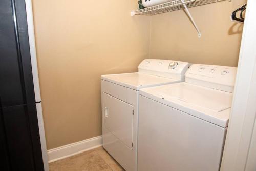 a small laundry room with a washer and dryer at 30A Getaway Too! in Santa Rosa Beach