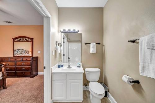 a bathroom with a white toilet and a sink at 30A Getaway Too! in Santa Rosa Beach